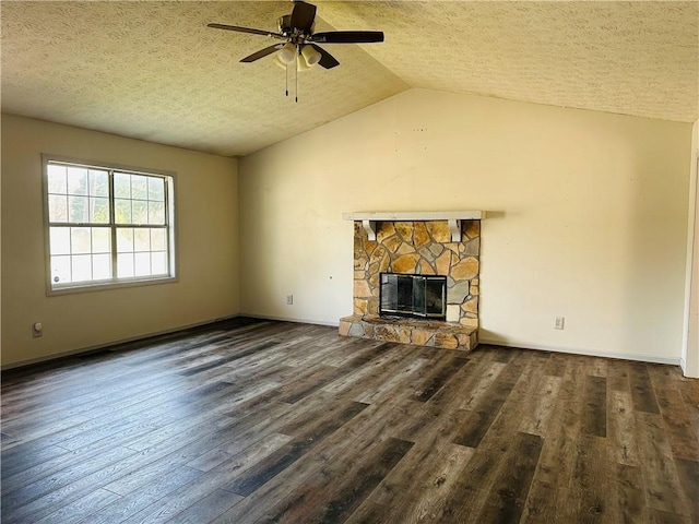 unfurnished living room featuring wood finished floors, lofted ceiling, a fireplace, ceiling fan, and a textured ceiling