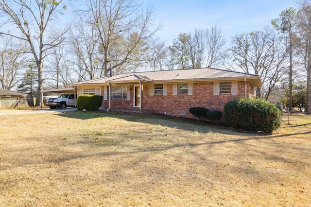 ranch-style house with a carport and a front lawn