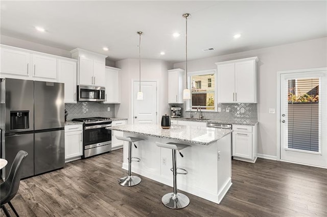 1590 Ridgebrook Downs, Mableton, GA 30126 - kitchen featuring appliances with stainless steel finishes, decorative backsplash, dark wood-style flooring, white cabinetry, and recessed lighting