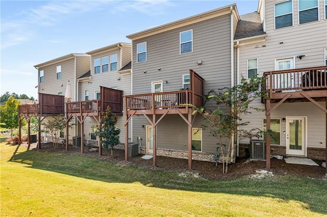 1590 Ridgebrook Downs, Mableton, GA 30126 - back of house featuring a lawn, a wooden deck, and central air condition unit