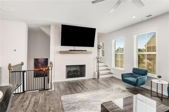 1590 Ridgebrook Downs, Mableton, GA 30126 - living area with wood finished floors, baseboards, ceiling fan, and a large fireplace