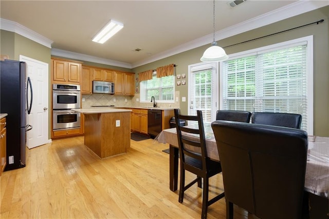 118 Brendylynn Trce, Woodstock, GA 30188 - kitchen with appliances with stainless steel finishes, a sink, crown molding, light wood-type flooring, and light countertops