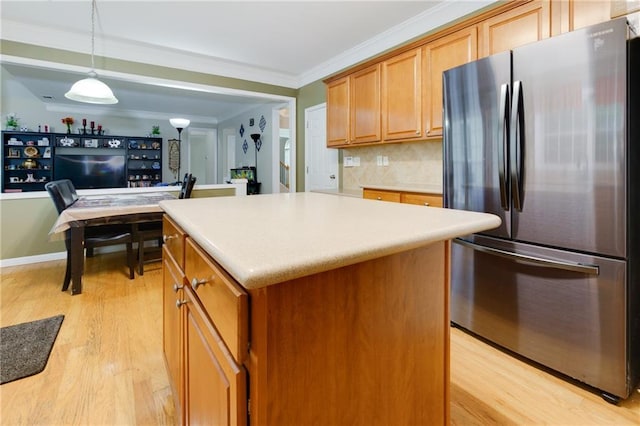 118 Brendylynn Trce, Woodstock, GA 30188 - kitchen featuring freestanding refrigerator, light wood-style flooring, a kitchen island, decorative backsplash, and crown molding