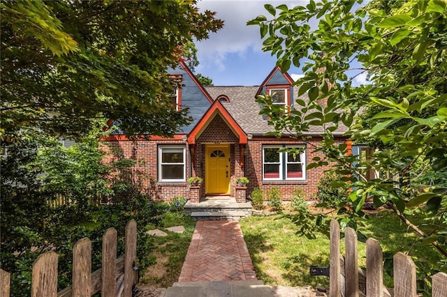 view of front of house featuring brick siding and a shingled roof