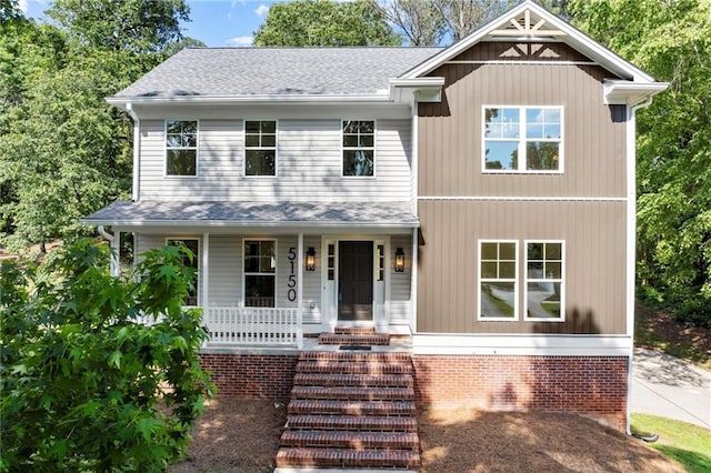 view of front of home with a porch and roof with shingles