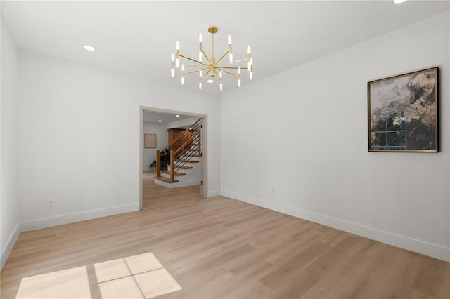 unfurnished room with a chandelier, stairs, wood finished floors, recessed lighting, and baseboards