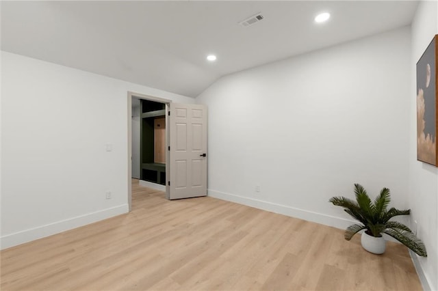 empty room with baseboards, light wood-type flooring, vaulted ceiling, and recessed lighting