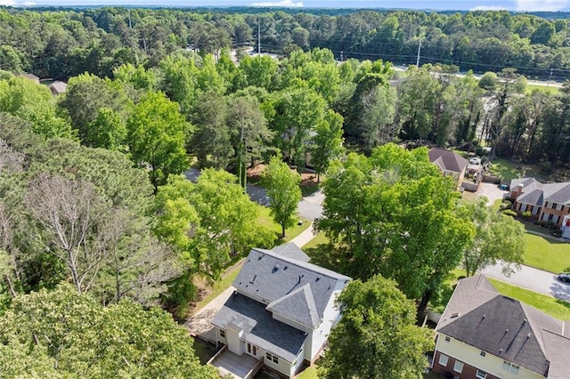 aerial perspective of suburban area with a heavily wooded area