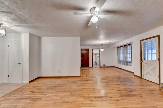 interior space featuring a textured ceiling, ceiling fan, and light hardwood / wood-style flooring