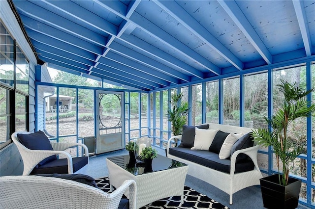 sunroom / solarium with lofted ceiling with beams