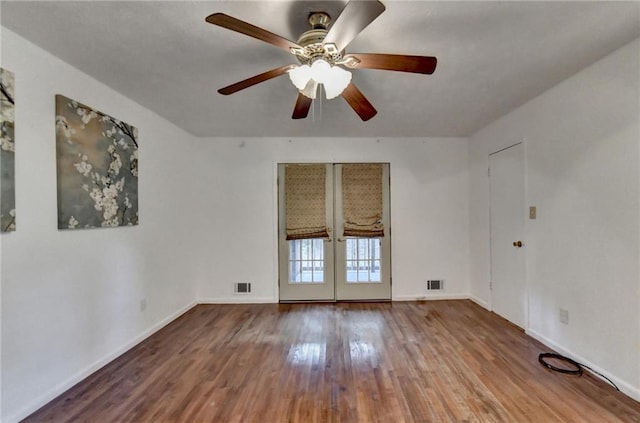 spare room with hardwood / wood-style floors, french doors, and ceiling fan