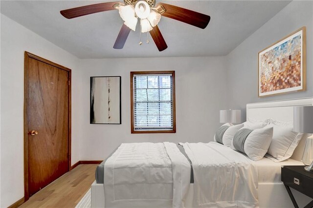 bedroom featuring light hardwood / wood-style flooring, a closet, and ceiling fan