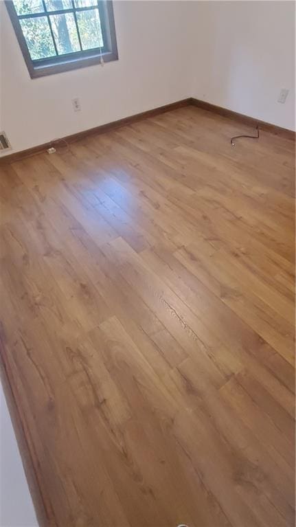 spare room with light hardwood / wood-style flooring