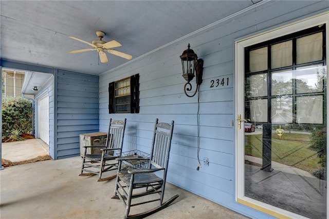 view of patio featuring a garage and ceiling fan