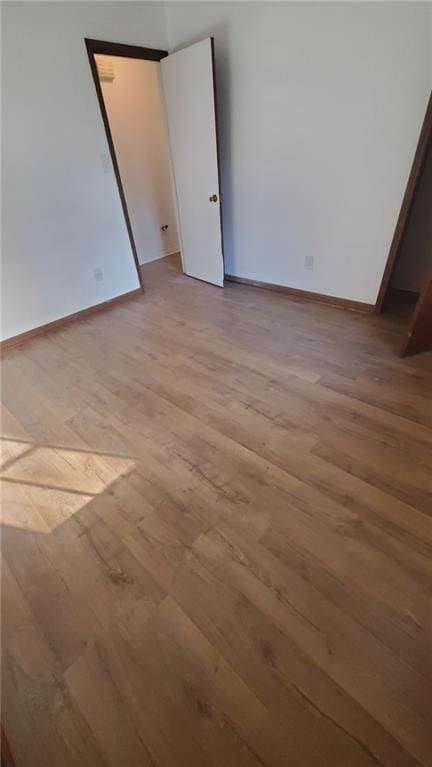 empty room with light hardwood / wood-style flooring