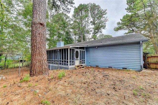 rear view of house with a sunroom