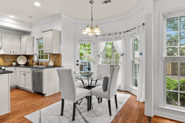 3242 Monarch Pine Dr, Peachtree Corners, GA 30071 - dining area featuring a chandelier, plenty of natural light, light wood-type flooring, ornamental molding, and recessed lighting