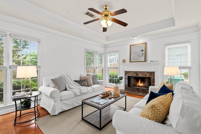 3242 Monarch Pine Dr, Peachtree Corners, GA 30071 - living room with ornamental molding, a tray ceiling, healthy amount of natural light, wood finished floors, and a ceiling fan