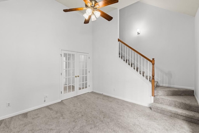 3242 Monarch Pine Dr, Peachtree Corners, GA 30071 - unfurnished living room featuring carpet floors, french doors, stairway, a ceiling fan, and high vaulted ceiling