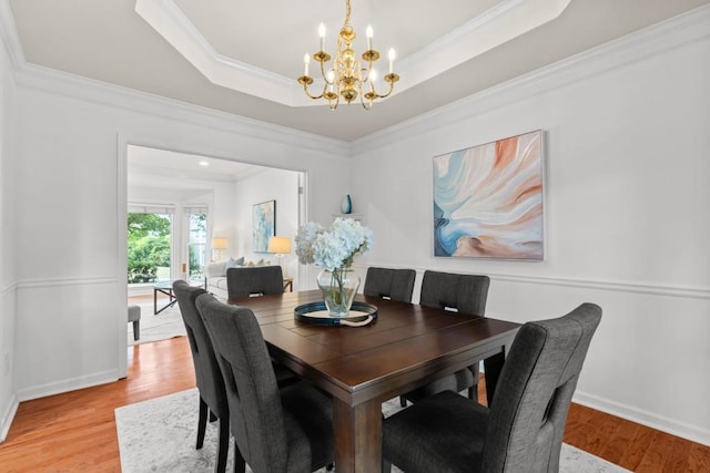 3242 Monarch Pine Dr, Peachtree Corners, GA 30071 - dining space with a chandelier, light wood finished floors, ornamental molding, a tray ceiling, and baseboards