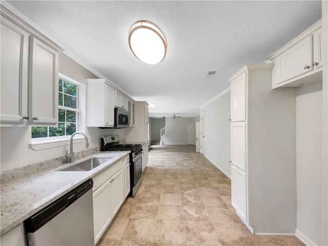 5159 Round Table Dr, Ellenwood, GA 30294 - kitchen with stainless steel appliances, white cabinets, and stone finish floors