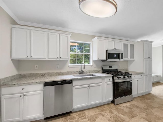 5159 Round Table Dr, Ellenwood, GA 30294 - kitchen with stainless steel appliances, white cabinets, ornamental molding, light stone countertops, and glass insert cabinets