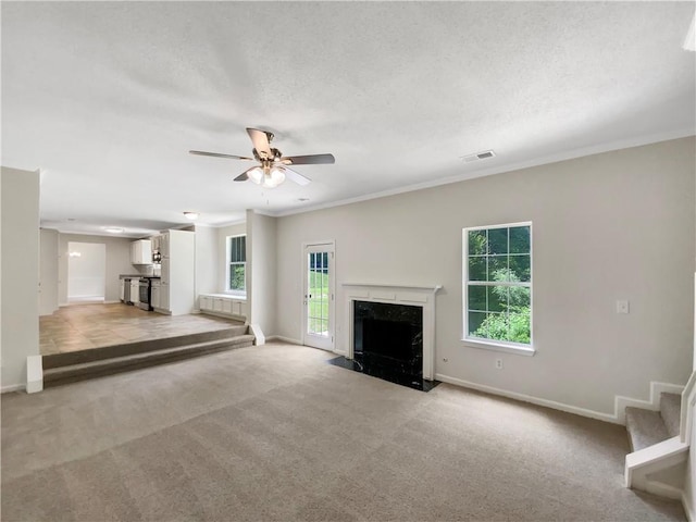 5159 Round Table Dr, Ellenwood, GA 30294 - unfurnished living room with light colored carpet, a ceiling fan, stairway, a premium fireplace, and ornamental molding