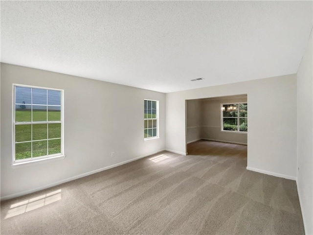 5159 Round Table Dr, Ellenwood, GA 30294 - spare room featuring carpet flooring and a textured ceiling