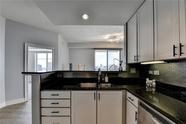 285 Centennial Olympic Park Dr NW Unit 1905, Atlanta, GA 30339 - kitchen with dishwasher, healthy amount of natural light, tasteful backsplash, dark stone countertops, and a textured ceiling