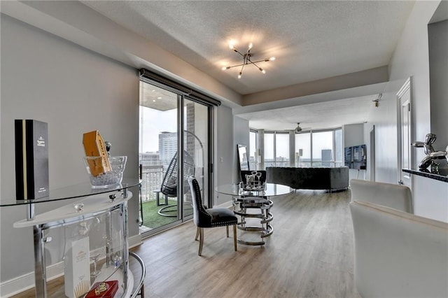 285 Centennial Olympic Park Dr NW Unit 1905, Atlanta, GA 30339 - dining area featuring wood finished floors, healthy amount of natural light, and a textured ceiling