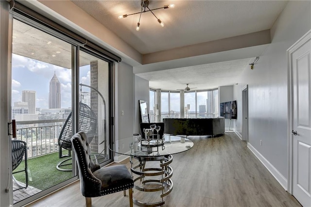 285 Centennial Olympic Park Dr NW Unit 1905, Atlanta, GA 30339 - dining room with wood finished floors, a skyline view, a chandelier, and ceiling fan