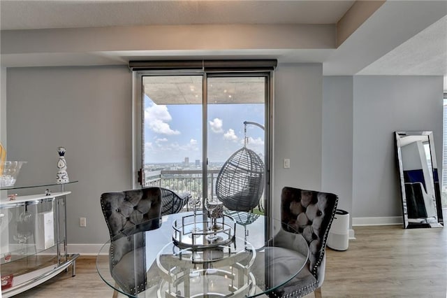 285 Centennial Olympic Park Dr NW Unit 1905, Atlanta, GA 30339 - dining area featuring baseboards and light wood-type flooring