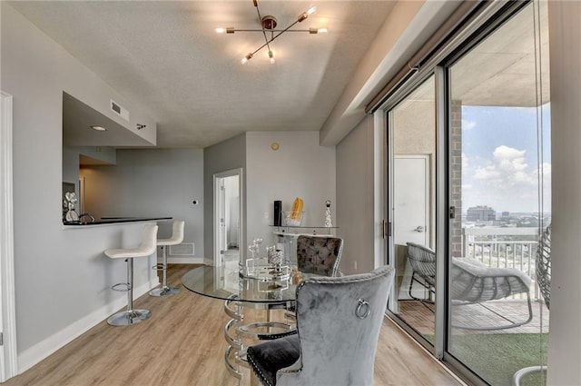 285 Centennial Olympic Park Dr NW Unit 1905, Atlanta, GA 30339 - dining area featuring light wood-style floors and a textured ceiling