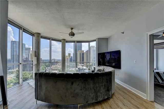 285 Centennial Olympic Park Dr NW Unit 1905, Atlanta, GA 30339 - living room with ceiling fan, light wood-style floors, a textured ceiling, and expansive windows