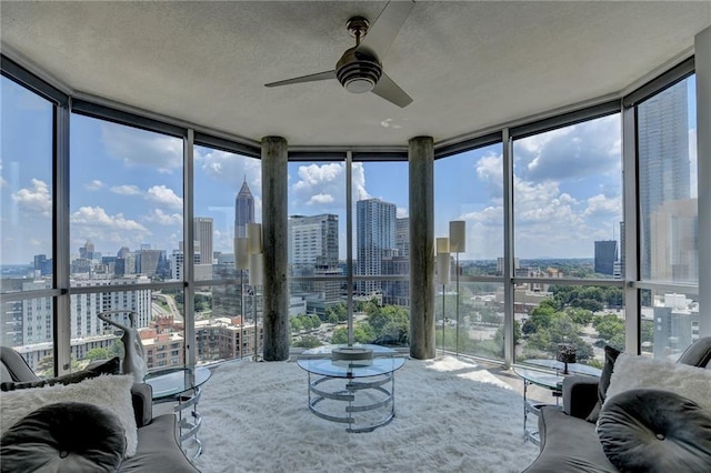 285 Centennial Olympic Park Dr NW Unit 1905, Atlanta, GA 30339 - living room featuring a view of skyline, floor to ceiling windows, a ceiling fan, and a textured ceiling