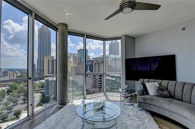 285 Centennial Olympic Park Dr NW Unit 1905, Atlanta, GA 30339 - living room with floor to ceiling windows, a view of skyline, a ceiling fan, and wood finished floors