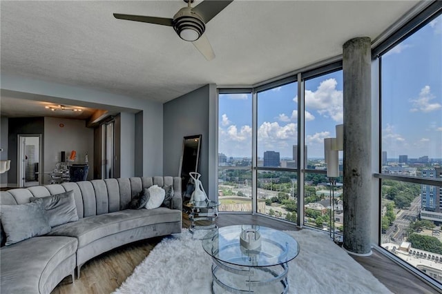285 Centennial Olympic Park Dr NW Unit 1905, Atlanta, GA 30339 - living room featuring floor to ceiling windows, a city view, wood finished floors, a ceiling fan, and plenty of natural light