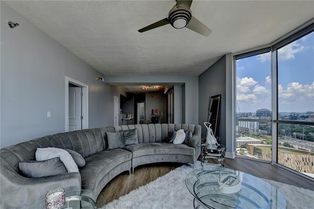 285 Centennial Olympic Park Dr NW Unit 1905, Atlanta, GA 30339 - living room with wood finished floors, healthy amount of natural light, a wall of windows, ceiling fan, and a city view