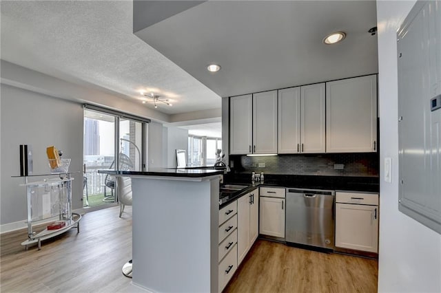 285 Centennial Olympic Park Dr NW Unit 1905, Atlanta, GA 30339 - kitchen featuring stainless steel dishwasher, light wood-type flooring, a peninsula, dark countertops, and recessed lighting