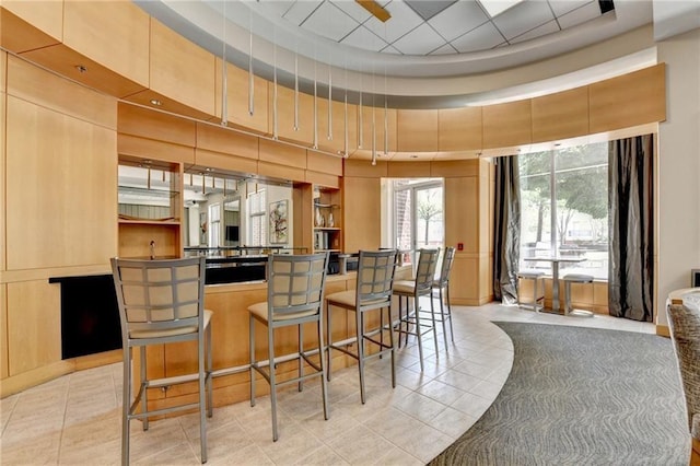 285 Centennial Olympic Park Dr NW Unit 1905, Atlanta, GA 30339 - bar featuring light tile patterned floors and a towering ceiling