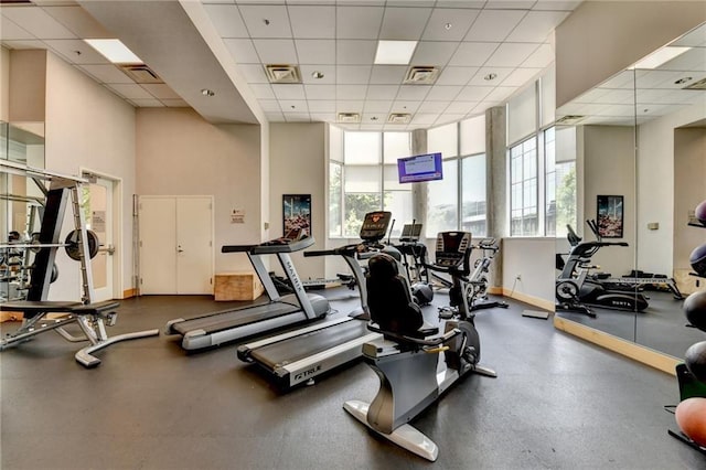 285 Centennial Olympic Park Dr NW Unit 1905, Atlanta, GA 30339 - gym with plenty of natural light, a paneled ceiling, and a towering ceiling