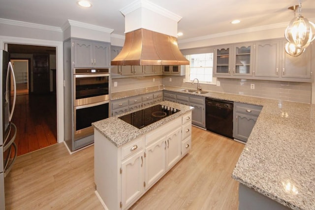 kitchen featuring light wood-type flooring, gray cabinetry, a sink, and black appliances