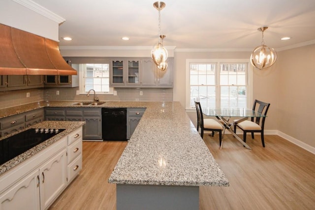 kitchen with light wood-style flooring, a sink, ornamental molding, backsplash, and black appliances