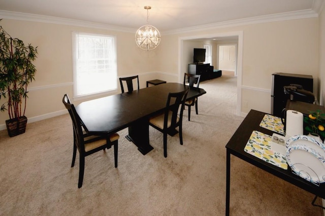 dining space featuring ornamental molding, a chandelier, and light colored carpet