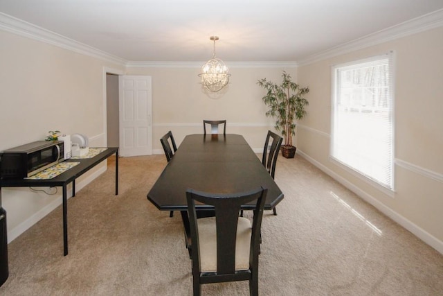 dining space featuring a chandelier, light colored carpet, and baseboards