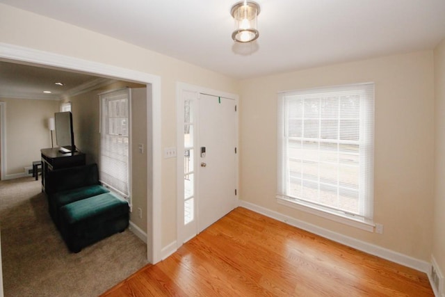 entrance foyer featuring light wood-style flooring and baseboards