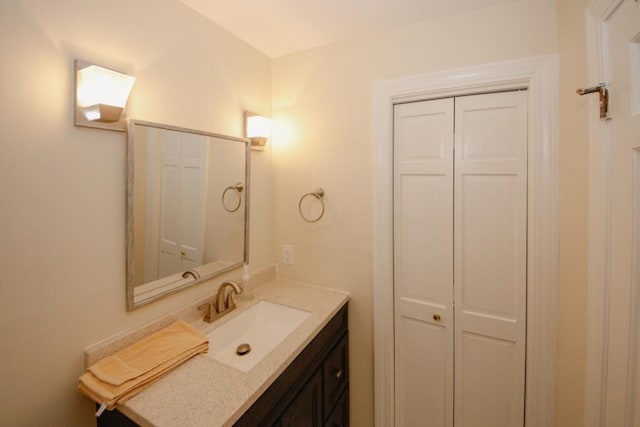 bathroom with a closet and vanity