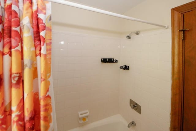 full bath featuring shower / tub combo with curtain