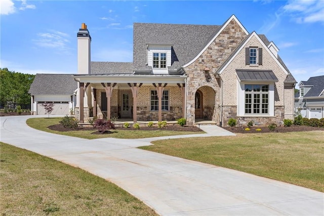 view of front of home featuring a standing seam roof, stone siding, metal roof, and covered porch