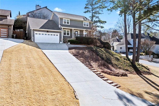 view of front of home featuring a garage, driveway, a chimney, fence, and a porch